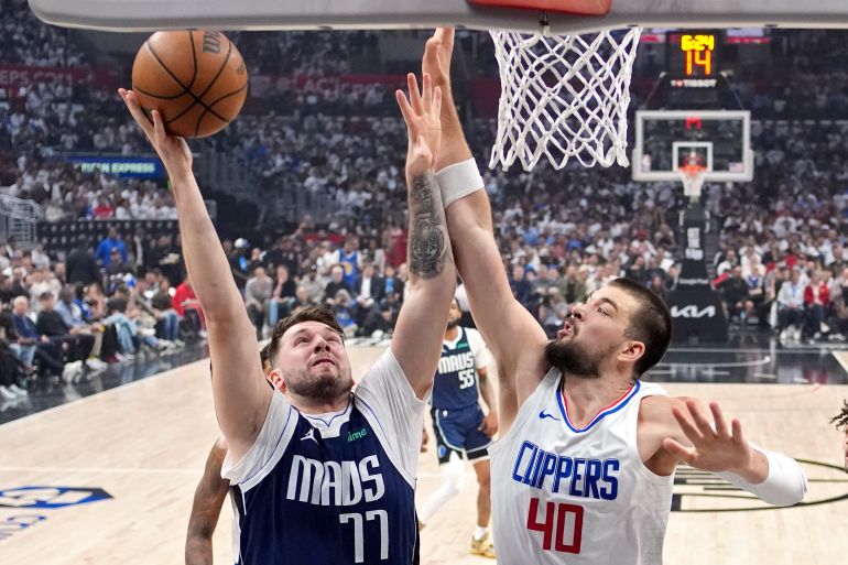 Dallas Mavericks guard Luka Doncic shoots as Los Angeles Clippers center Ivica Zubac defends