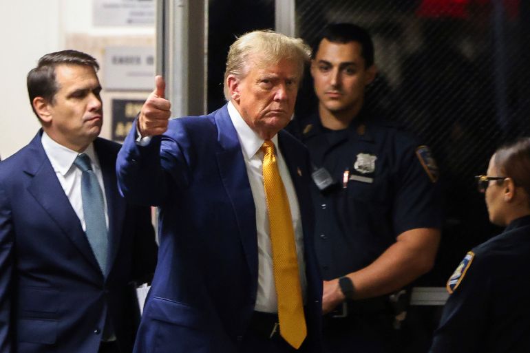Donald Trump flashes a thumbs-up as he returns to the Manhattan criminal courthouse.