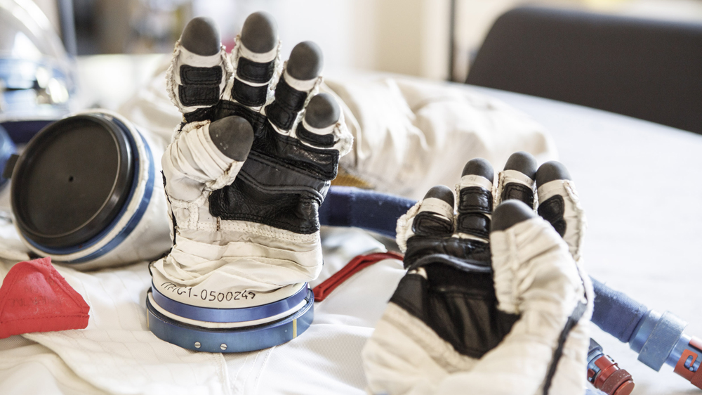 Gloves worn by astronauts travelling aboard the Russian Sokhol spacecraft to the International Space Station (from Chris Hadfield's personal collection) [Mark Kensett / Al Jazeera]