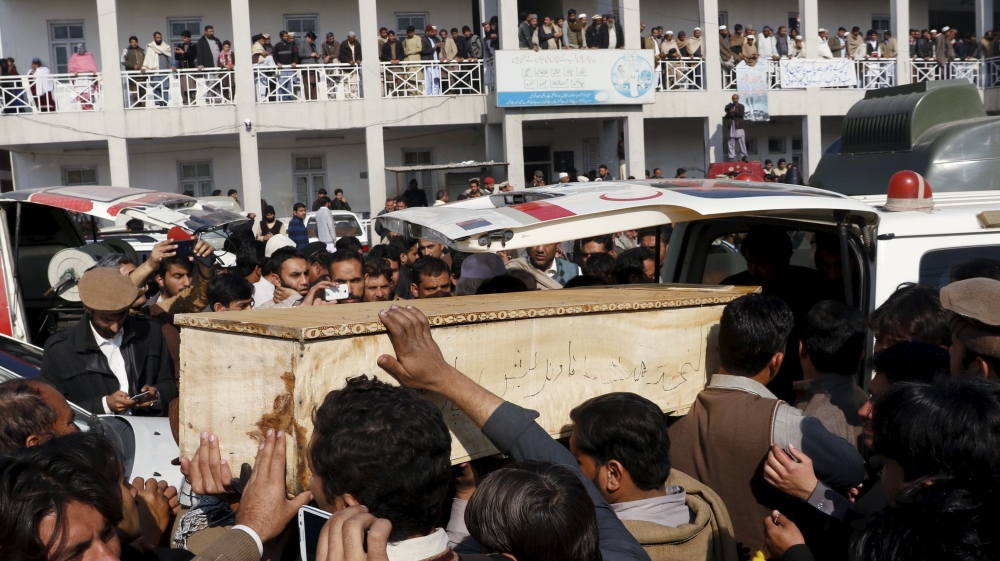 Relatives and friends surround the coffin of a student who was killed in the attack on Bacha Khan University [Khuram Parvez/Reuters]