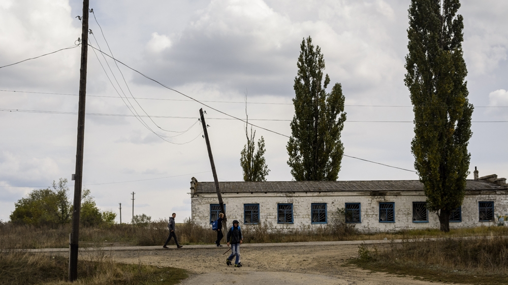 Schoolchildren near Troitske, in the Luhansk region. The village has been at the centre of fighting for a year, and faces a continuing threat from unexploded ordnance  [Benas Gerdziunas/Al Jazeera]