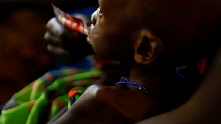A mother feeds her child with a peanut-based paste for treatment of severe acute malnutrition in a UNICEF supported hospital in the capital Juba, South Sudan