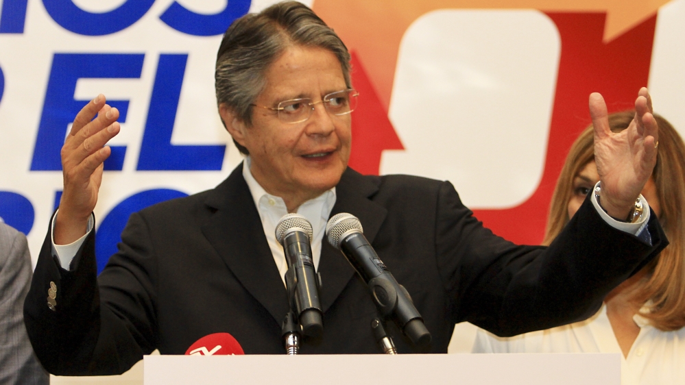 Presidential candidate Guillermo Lasso speaks to reporters on Monday [EPA]