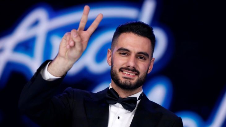 Palestinian singer Yaqoub Shaheen, gestures after being announced winner of Arab Idol season 4, in Zouk Mosbeh area, north of Beirut