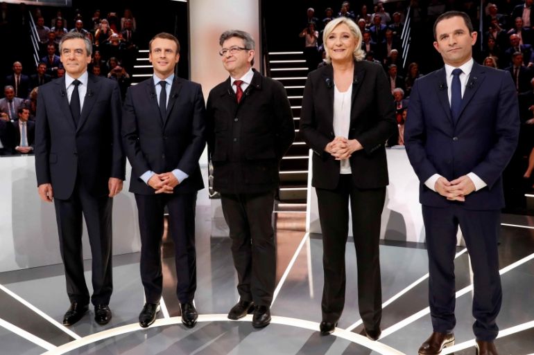 French presidential election candidates (LtoR) Francois Fillon, Emmanuel Macron, Jean-Luc Melenchon, Marine Le Pen and Benoit Hamon, pose before a debate organised by French private TV channel TF1 in