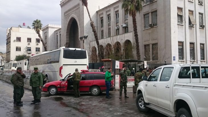 Syrian security forces corden off an area near the Damascus Justice Palace follwing a suicide attack