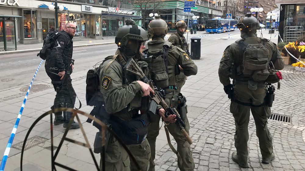 Police officers stand guard in central Stockholm after the truck attack on Friday [Daniel Dikson/Reuters]