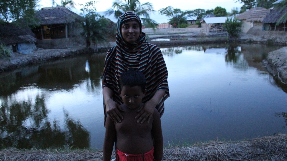 Khadija holds her son, Muttakin Amir, who is now nearly five years old. Because of the salty water in the area, he often falls sick [Neha Thirani Bagri/The GroundTruth Project]