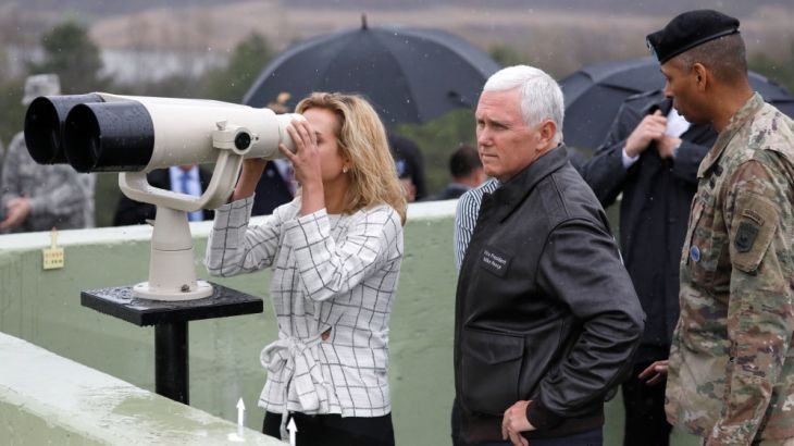 U.S. Vice President Mike Pence stands next to his daughter looking toward the north through a pair of binocular from an observation post inside the demilitarized zone separa