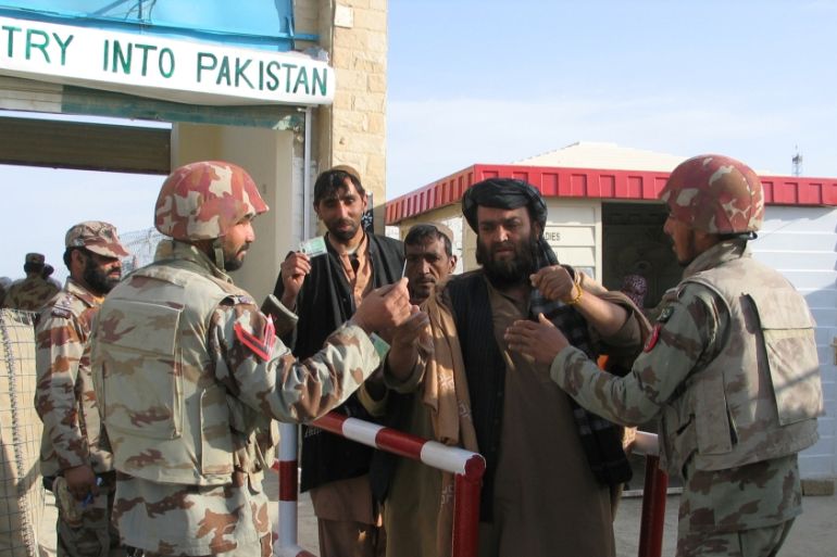 Pakistani soldiers check the identity of citizens returning from Afghanistan at the border town of Chaman