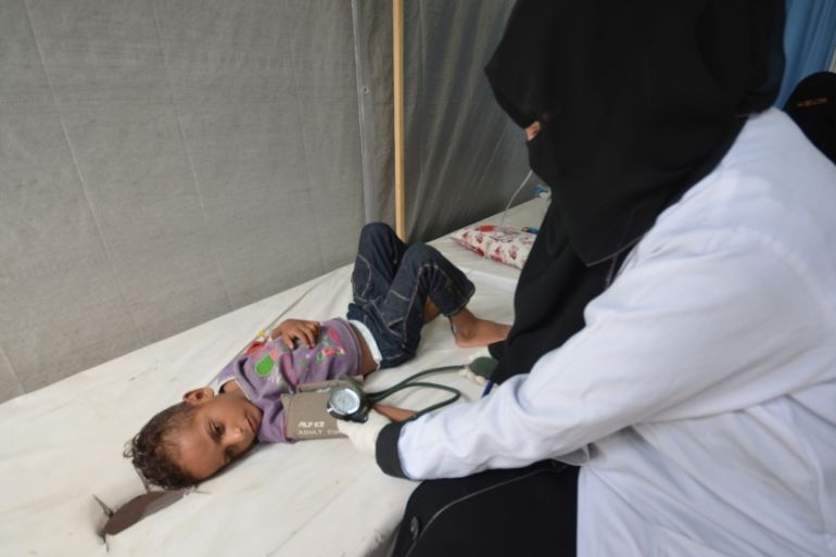Nurse attends to a boy infected with cholera at a hospital in the Red Sea port city of Hodeidah, Yemen