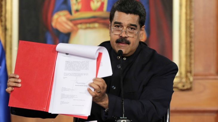 Venezuela''s President Nicolas Maduro holds a document as he speaks during a ceremony at Miraflores Palace in Caracas