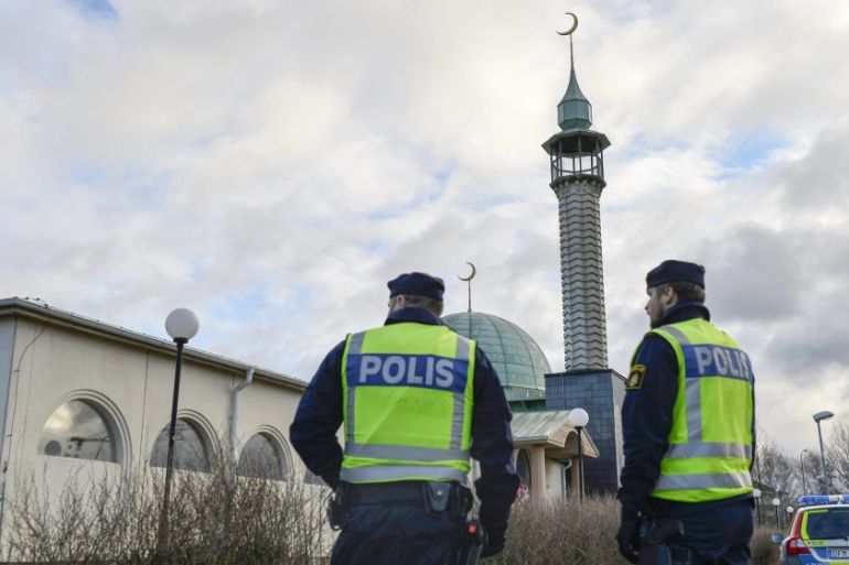 Policemen stand outside a mosque in Uppsala