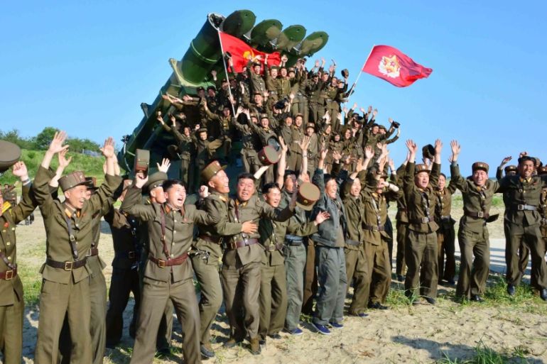 Members of the Korean People''s Armed Forces react after doing a test-fire of new cruise rocket