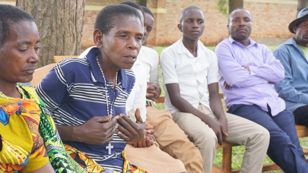 Members of the peace club sponsored by International Alert in the Muganza sector of Rwanda's Gisagara District gather to share their stories [Valerie Hopkins/Al Jazeera]