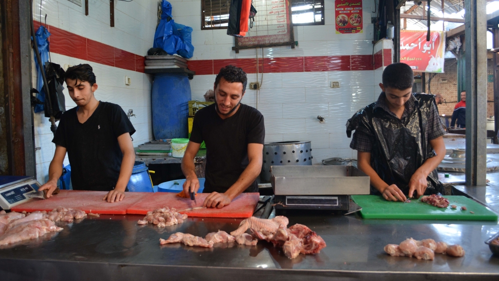 Muhammad Hamid (centre) says he and his colleagues at a butcher shop in Jabaliya often make no money [Mersiha Gadzo/Al Jazeera]