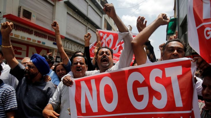 Traders shout slogans during a day-long strike against Goods and Services Tax (GST)