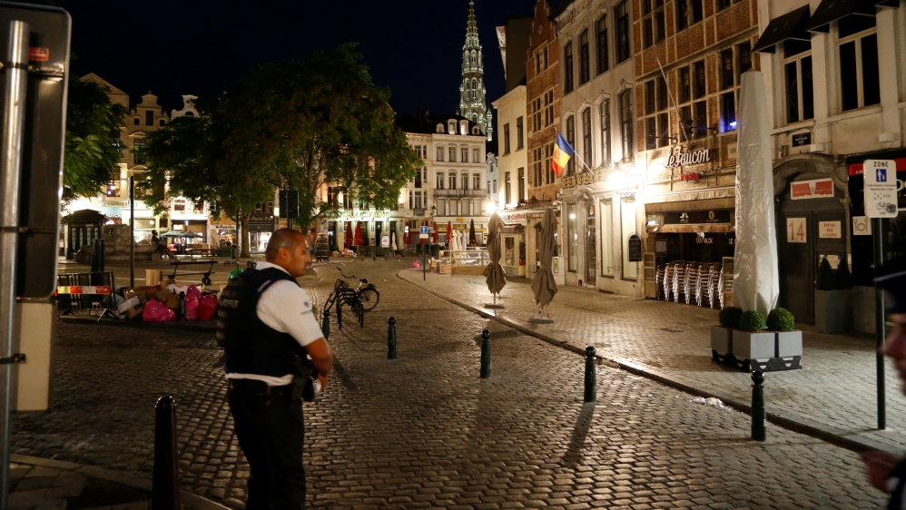 A policeman stands guard over a deserted street near Central Station [Francois Lenoir/Reuters]