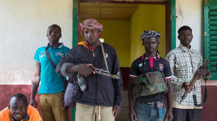 Members of the of the Anti-Balaka armed militia pose as they display their weapons in the town of Bocaranga, Central African Republic