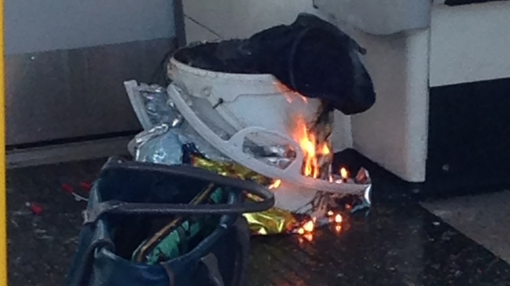 A handout picture obtained from Twitter user @RRigs shows a white container burning inside a London Underground [AFP]