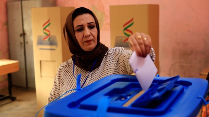 An employee casts her vote at a polling station for Kurds independence referendum in Kirkuk