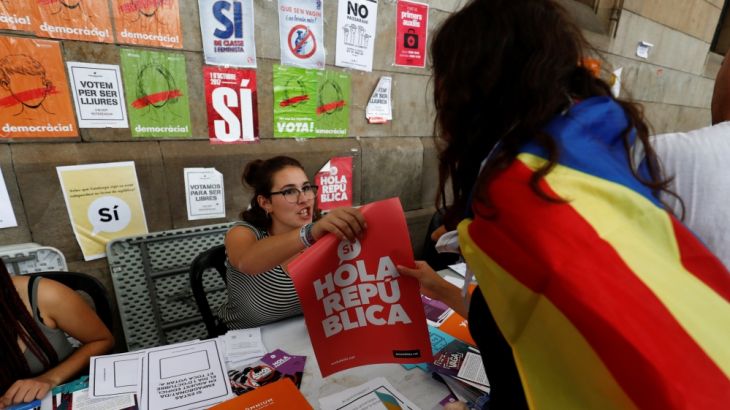 Students offer information to citizens about the banned October 1 independence referendum outside the university in Barcelona