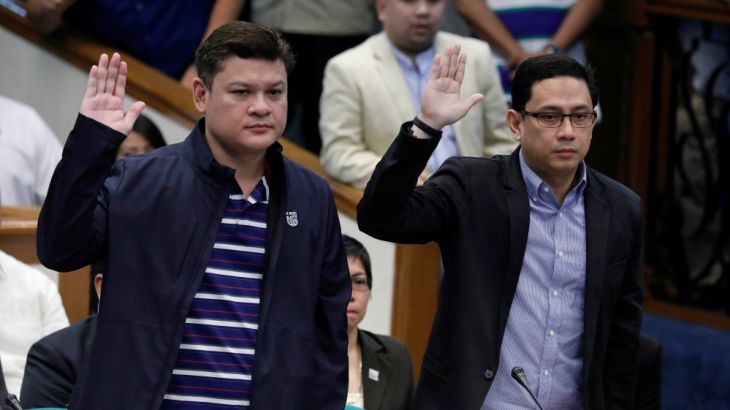 Paolo Duterte, Davao Vice Mayor and son of President Rodrigo Duterte, and his brother in law Manases Carpio take oath during a Senate hearing on drug smuggling in Pasay, Metro Manila