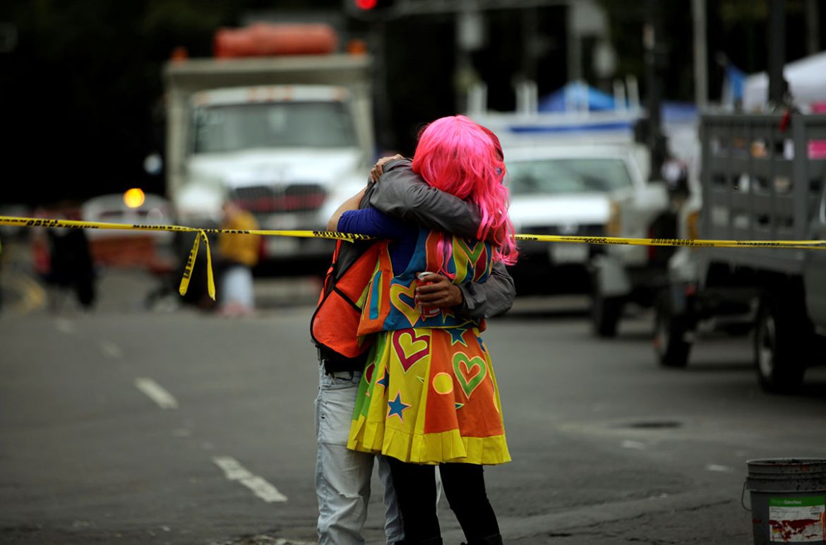 A woman embraces a member of the rescue team outside a collapsed building at Alvaro Obregon Avenue in the Condesa neighborhood. REUTERS/Jose Luis Gonzalez
