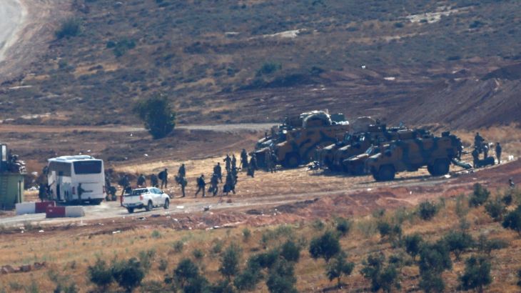 Turkish military vehicles are seen on the Turkish-Syrian border line in Reyhanli