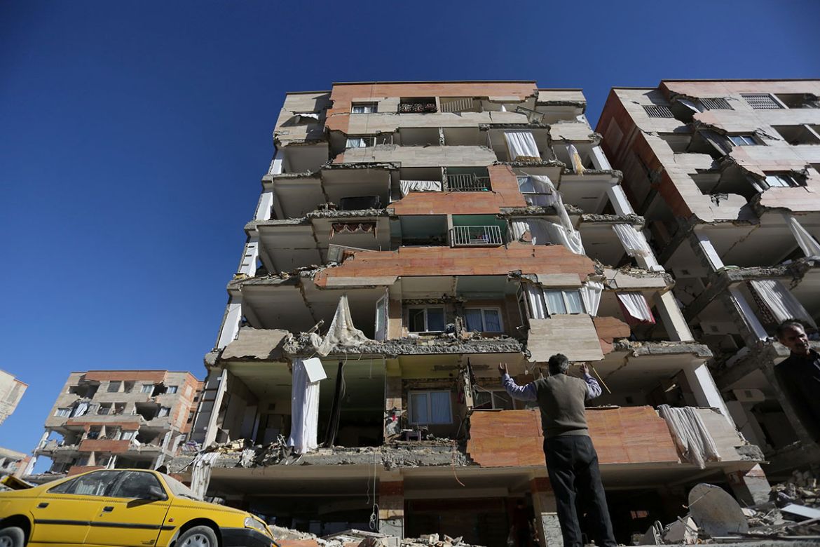 A man reacts as he looks at a damaged building following an earth quake in Sarpol-e Zahab county in Kermanshah, Iran. REUTERS/Tasnim News Agency