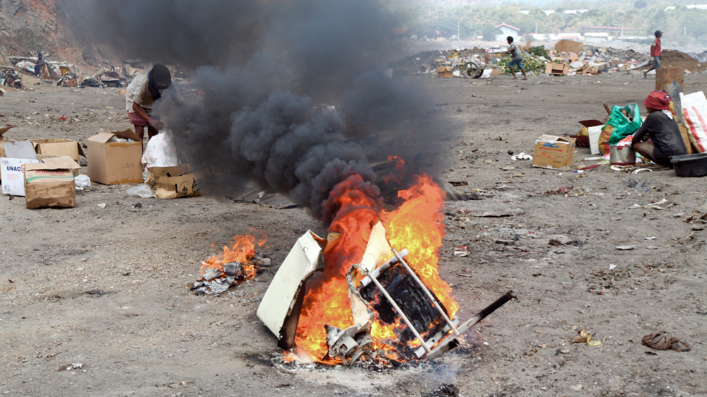 Explosions are common at the dump as aerosol cans detonate in the fires [Ian Lloyd Neubauer/Al Jazeera]