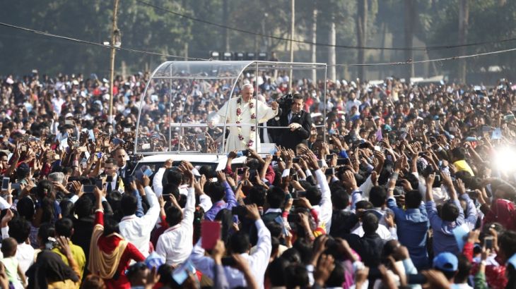 Pope Francis waves to faithful as he arrives arrives to celebrate mass and the ordination of new priests in Dhaka, Bangladesh. [Aijaz Rahi/AP Photo]