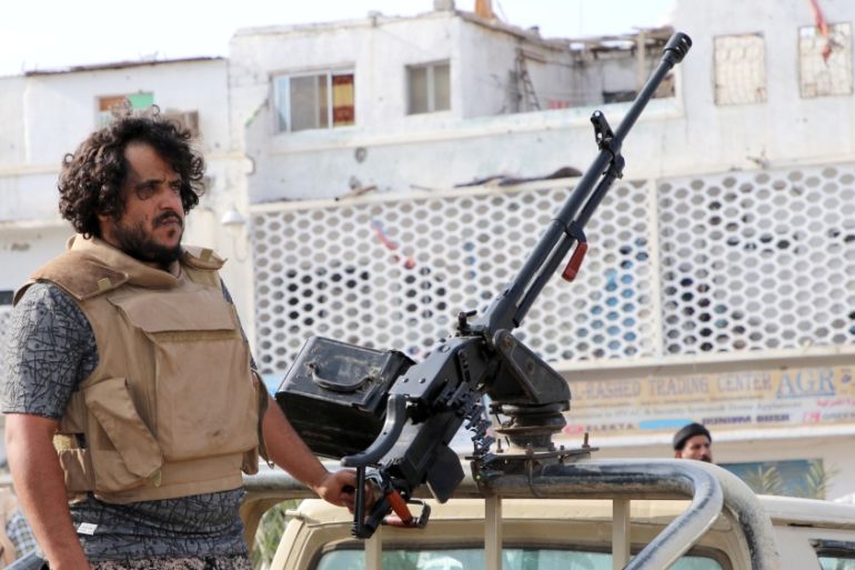 A fighter of the southern Yemeni separatists mans a machine gun mounted on a military vehicle securing an anti-government protest in Aden