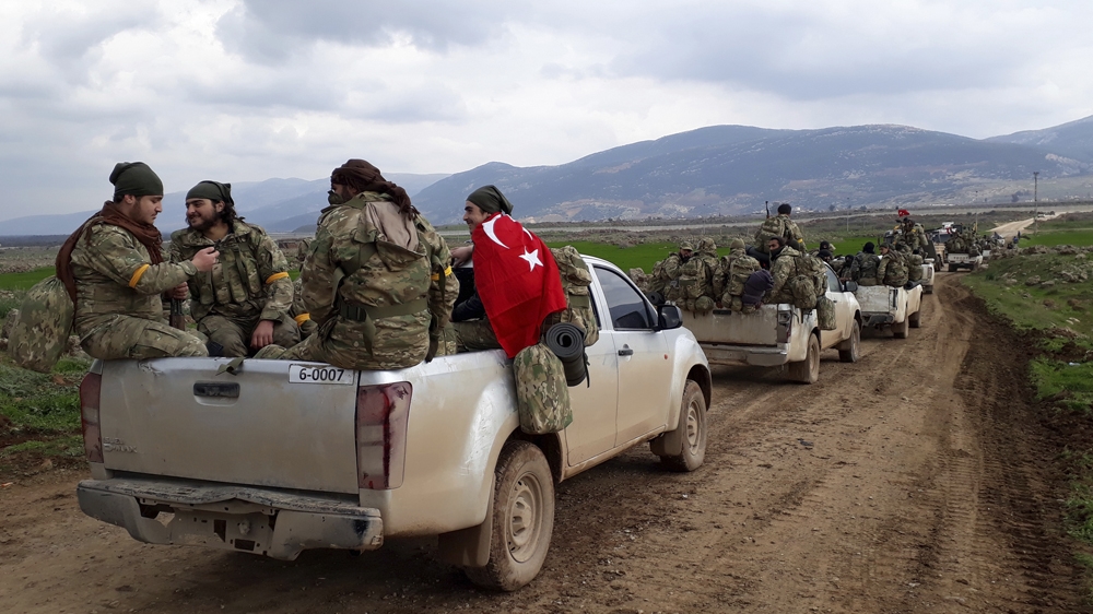 Free Syrian Army fighters head towards Afrin as part of the Turkish operation [AP]