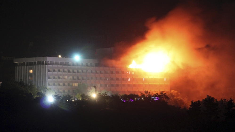 A 2011 image showing smoke and flames rising from the hotel after coming under attack [Reuters]