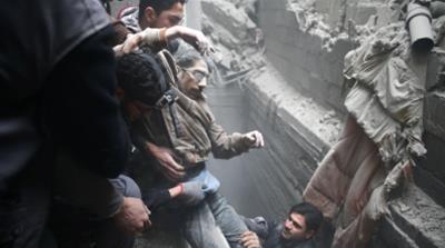 Civil defence help a man from a shelter in the besieged town of Douma in Eastern Ghouta [Bassam Khabieh/Reuters]