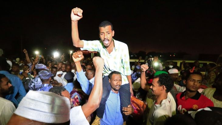 Supporters carry a released politician outside the National Prison, after demonstrations in Khartoum