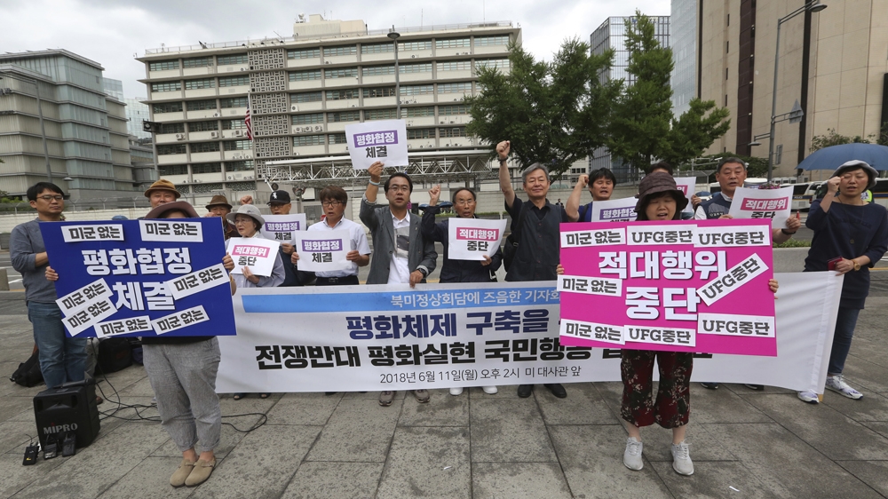 
Activists root for a successful summit at a rally near the US embassy in Seoul, South Korea [Ahn Young-joon/The Associated Press]
