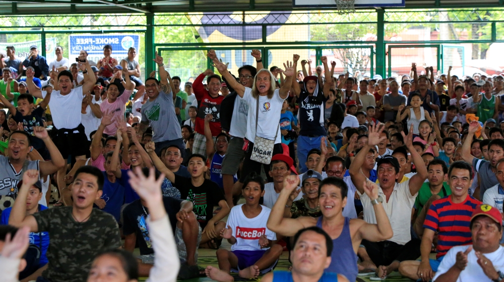 Fans watch a televised broadcast of the match in Marikina, Philippines [Czar Dancel/Reuters]