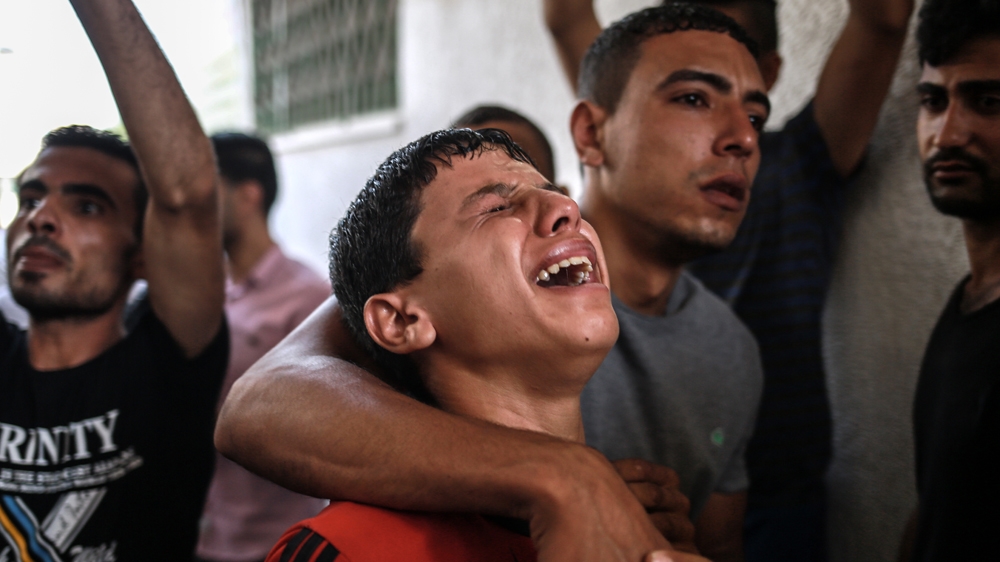 Relatives grieve after the death of the two teenage boys [Hosam Salem/Al Jazeera]
