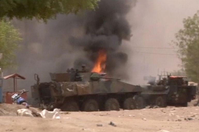 A still image taken from a video shows an armoured personnel carrier on fire after a car bomb attack in Gao
