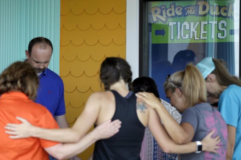 People pray outside Ride the Ducks, an amphibious tour operator involved in last night''s duck boat accident on Table Rock Lake, Friday, July 20, 2018 in Branson, Mo.