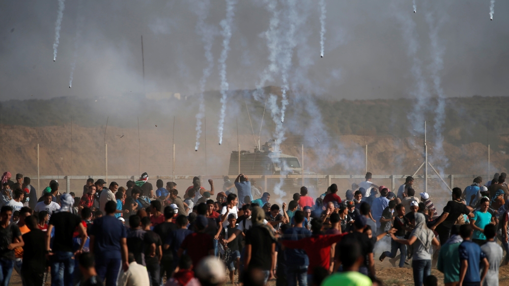 Israeli forces fire tear gas towards Palestinian demonstrators in Gaza [Mohammed Salem/Reuters]