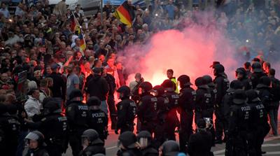 Riot policemen protected far-right demonstrators against attacks from anti-fascists in Chemnitz [Matthias Rietschel/Reuters]
