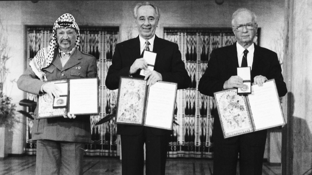 PLO leader Yasser Arafat, Israeli PM Yitzhak Rabin, and Israeli FM Shimon Peres pose with their medals and diplomas, after receiving the 1994 Nobel Peace Prize in Oslo's City Hall for their role in the Oslo peace accords of 1993 [AP]