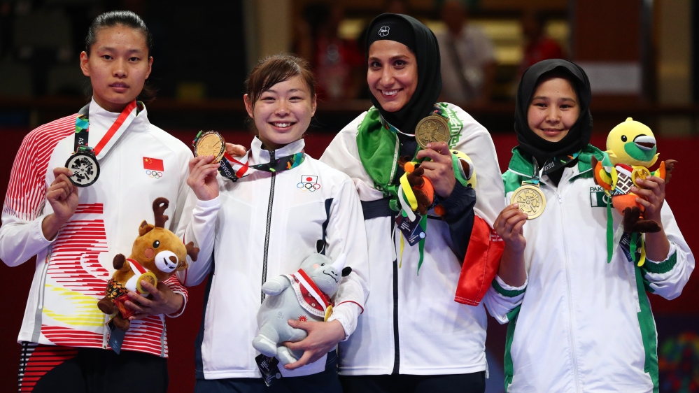 Nargis (R) on the podium for the women's karate 68kg medal ceremony in Jakarta, Indonesia [Athit Perawongmetha/Reuters]