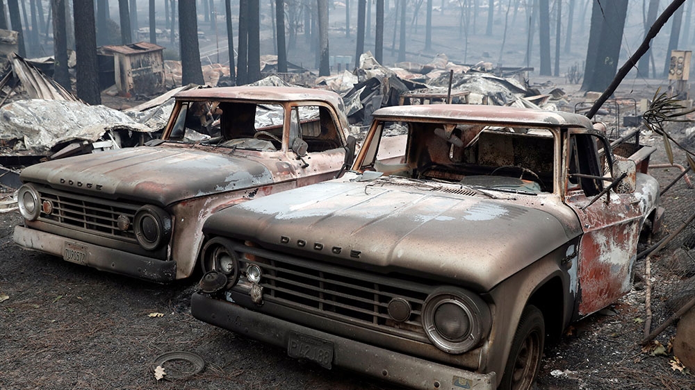 Trucks destroyed by the Camp Fire are seen in Paradise, California [Terray Sylvester/Reuters]