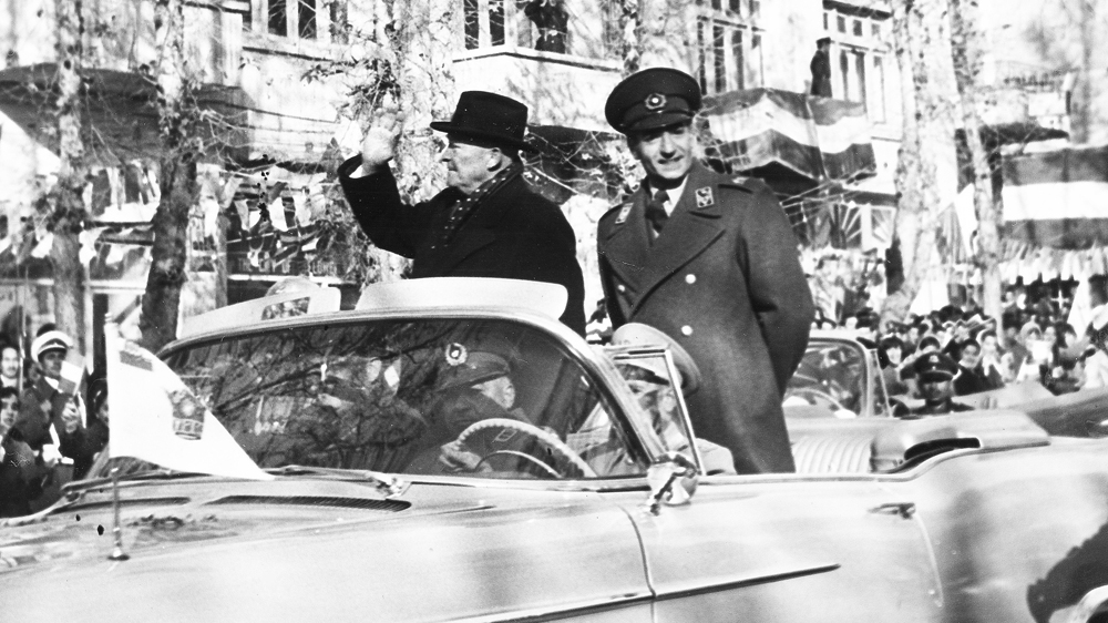 Iran's Shah Mohammad Reza Pahlavi and US President Eisenhower drive through cheering crowds in Tehran in 1959 [File: AP]