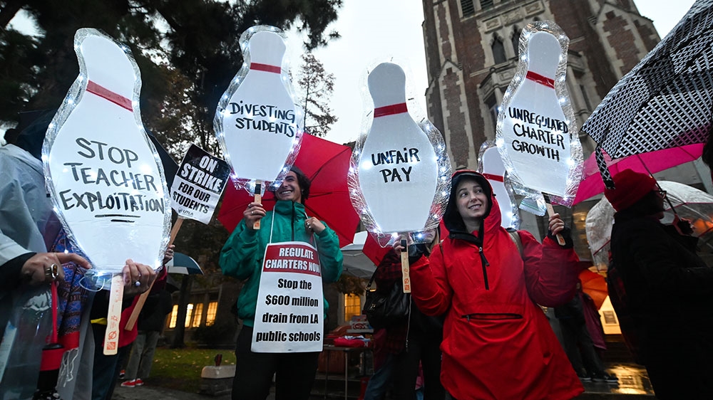 Teachers and their supporters picket outside John Marshall High School in Los Angeles, California on the first day of the teachers' strike [Robyn Beck/AFP] 