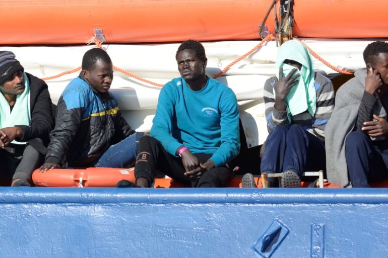 Migrants rest on board the Sea Watch 3 off the coast of Siracusa